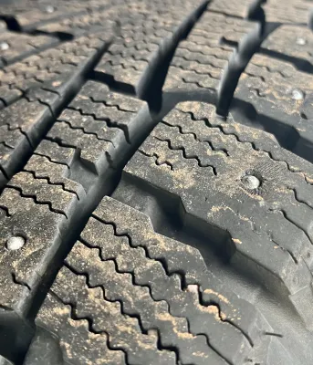 image of tire with metals studs in it