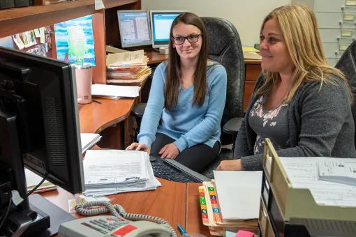 Two women looking at a computer
