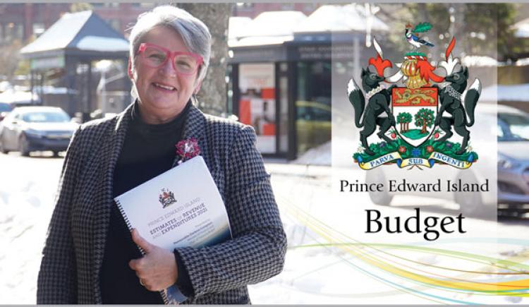 Image of Hon. darlene Compton, Minister of Finance holding 2021/21 budget