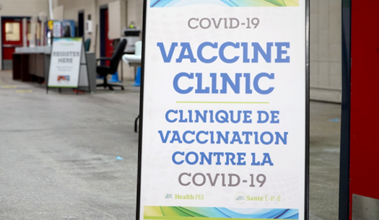 Image of a sandwich board sign for a Covid 19 Vaccinc clinic