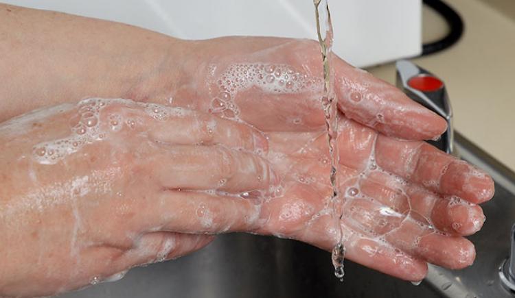 Image of female washing her hands