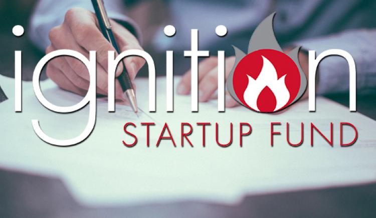 Ignition Fund logo and hands holding a pen